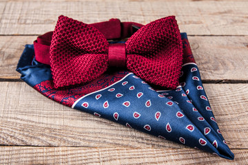 Red bow tie on a wooden background