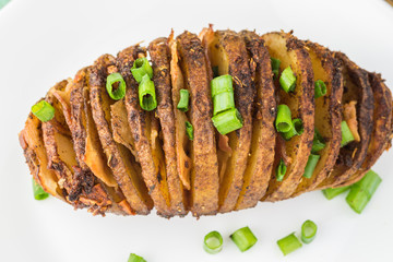 Hasselback potato with smoked paprika and bacon.