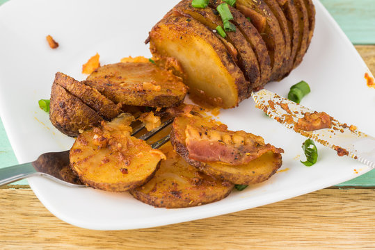 Hasselback potato with smoked paprika and bacon.