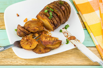 Hasselback potato with smoked paprika and bacon.