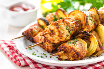 Grilled shish kebab or shashlik on skewers closeup on white background
