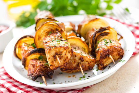 Grilled shish kebab or shashlik on skewers closeup on white background