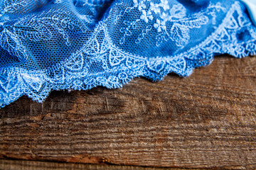 Feminine blue underclothes on white wooden background