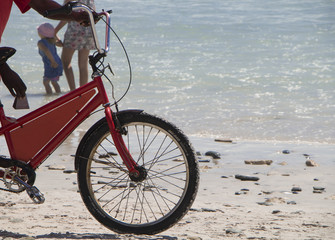 ice cream bicycle on beach with child and mother in background