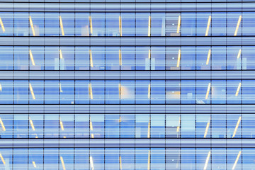 Fototapeta na wymiar Blue skyscraper facade. Glass and steel structure background.
