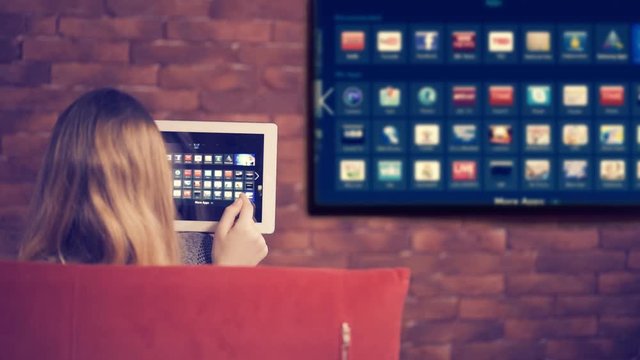 Closeup of a tablet is connected to a smart TV.