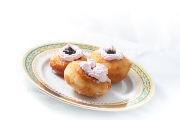 sweet donuts with cream on a plate
