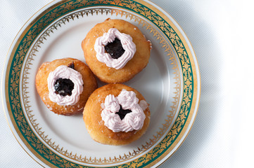 sweet donuts with cream on a plate