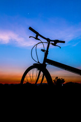 silhouette a lonely bike  sunset time.