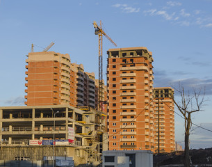 Fototapeta na wymiar Three brown building under construction