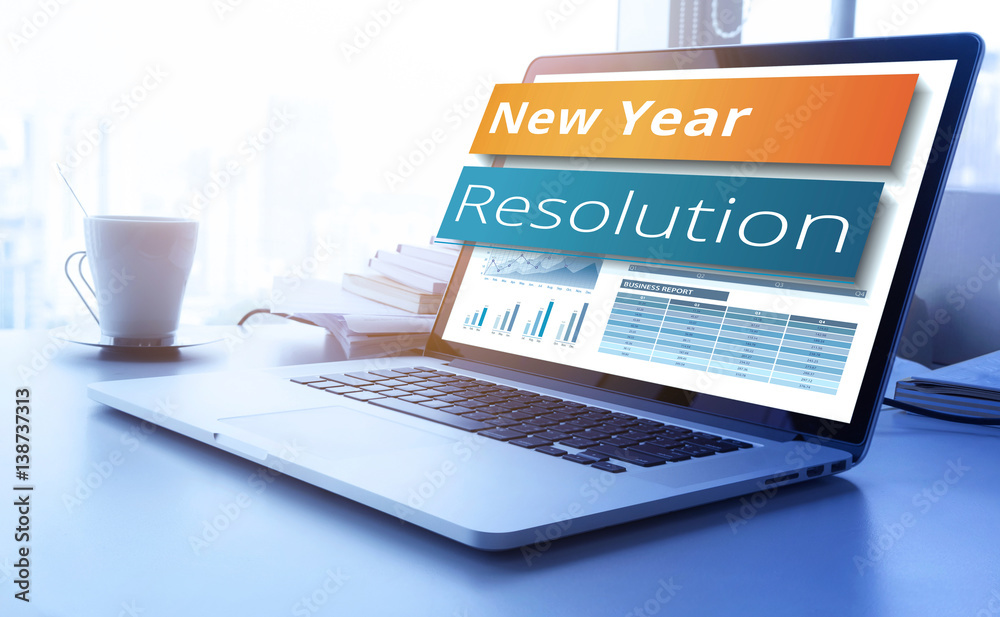 Wall mural .new year resolution text on laptop screen with graph chart background.business marketing,success an