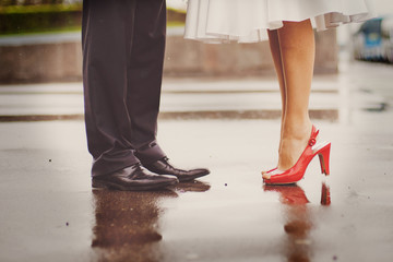 Feet in footwear of the groom and the bride - Powered by Adobe