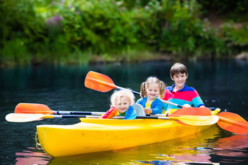 Kids kayaking on a river