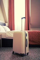 Detail of a hotel room with a suitcase