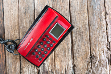 red telephone on wood background old style