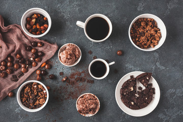 Cups of coffee, chocolate cake, chocolate muesli and chocolate ice cream on dark background. Flat lay, top view