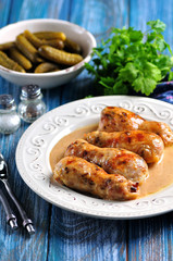 Baked chicken drumsticks stuffed with fried mushrooms and cheese in a creamy sauce.