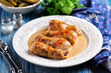 Baked chicken drumsticks stuffed with fried mushrooms and cheese in a creamy sauce.