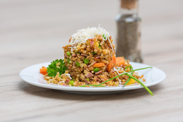 Bulgur vegetable salad with goat cheese on wooden table