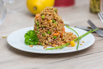 Bulgur vegetable salad on wooden table
