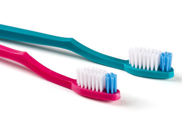Two toothbrushes isolated on a white background closeup