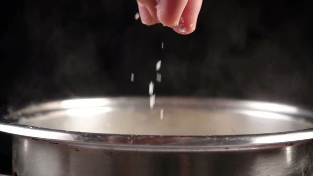 Add a salt to boiling water in metal pot, slow motion