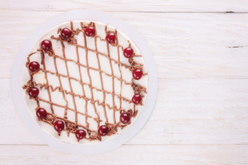 Chocolate cake with mousse, decorated cherries
