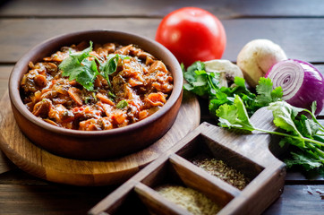 Georgian Satsivi with mushrooms onions and tomatoes in a clay plate