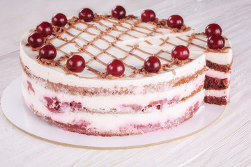 Chocolate cake with mousse, decorated cherries