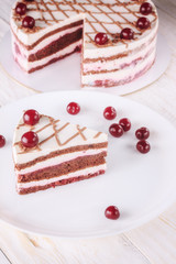Chocolate cake with mousse, decorated cherries