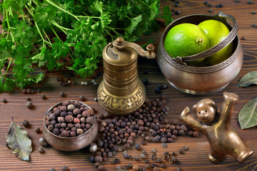 spices, lime, silver utensils and pepper mill
