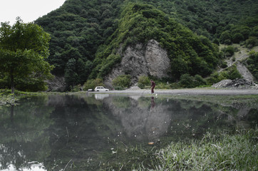 Summer landscape of reflected trees in a perfectly still water of lake with dramatic Latrigg mountain backdrop in Azerbaijan. Caucasus Gakh