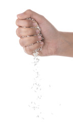 Hands dropping rice grain isolated on white background.