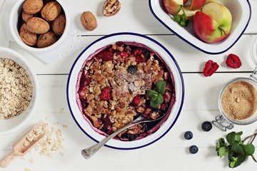 Apple-berry crumble with oatmeal and nuts crunch. Clean eating concept.Rustic style.