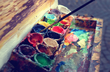 Artist at work. The workplace of the artist, brushes, paints and canvas. Multicolor oil paints on a...