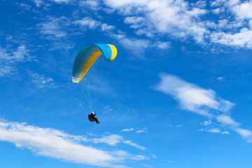 Skydiver in the blue sky with clouds