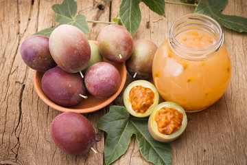 Passion fruit and its pulp on a wooden background, fruit originating in the south of America.