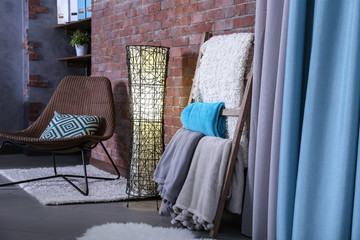 Warm plaids on decorative wooden ladder at home