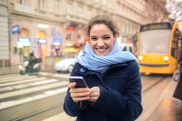 Happy girl holding a smartphone
