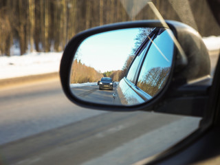 look in the rearview mirror of a car
