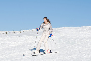 Fototapeta na wymiar Woman skiing in white costume