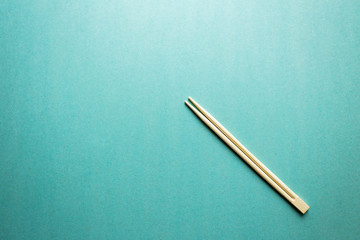 two Chinese chopsticks on the aqua background