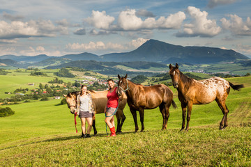 Two girls with a horse on a field in Slovakia