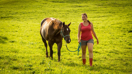 Girl with a horse on a field in Slovakian region Orava