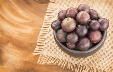 Berry Jaboticaba on wooden table (Plinia cauliflora)