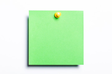 Green note pined isolated on white. Empty reminder card.