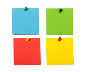 Blue, yellow, green and red reminder cards pined isolated on white. Empty square memo card.