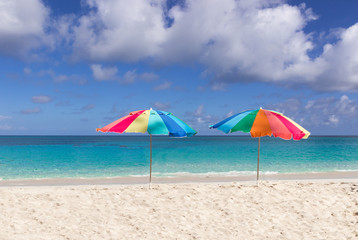 Two colorful beach umbrellas
