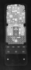 TV remote control under X-rays in negative. Visibility through. Image was obtained with real X-ray machine.