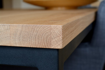 Wooden table top corner closeup.